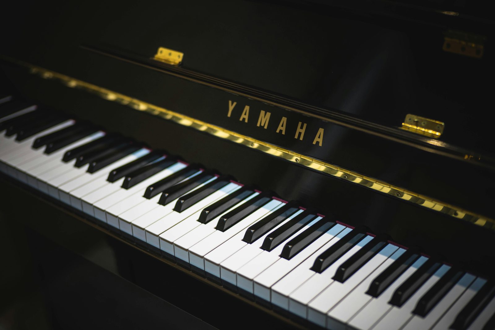 Musician performing on a grand piano at CJ Music Academy